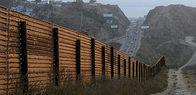 Brown border fence along road
